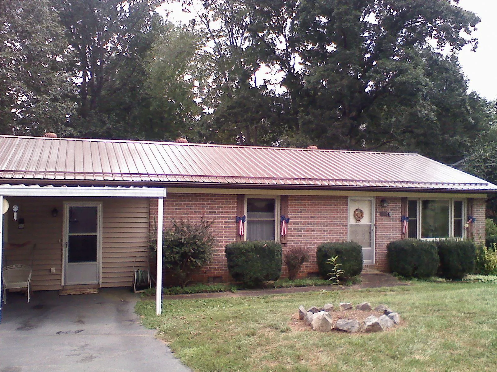 Bronze metal roof and carport on a brick ranch home — Roof Repair work by our crew in Cheney
