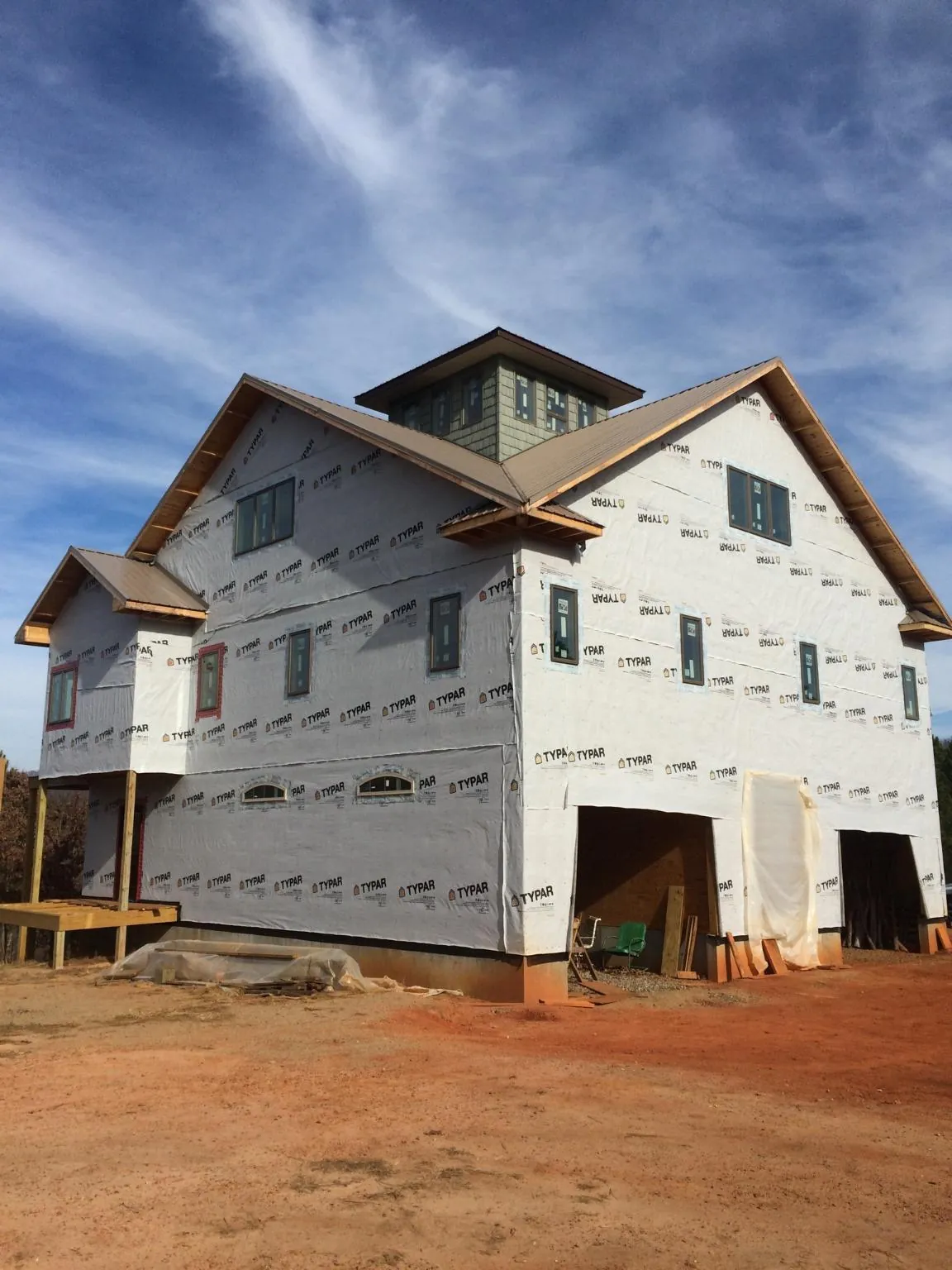 New two story house under construction with a cupola and gabled roofs in Cheney